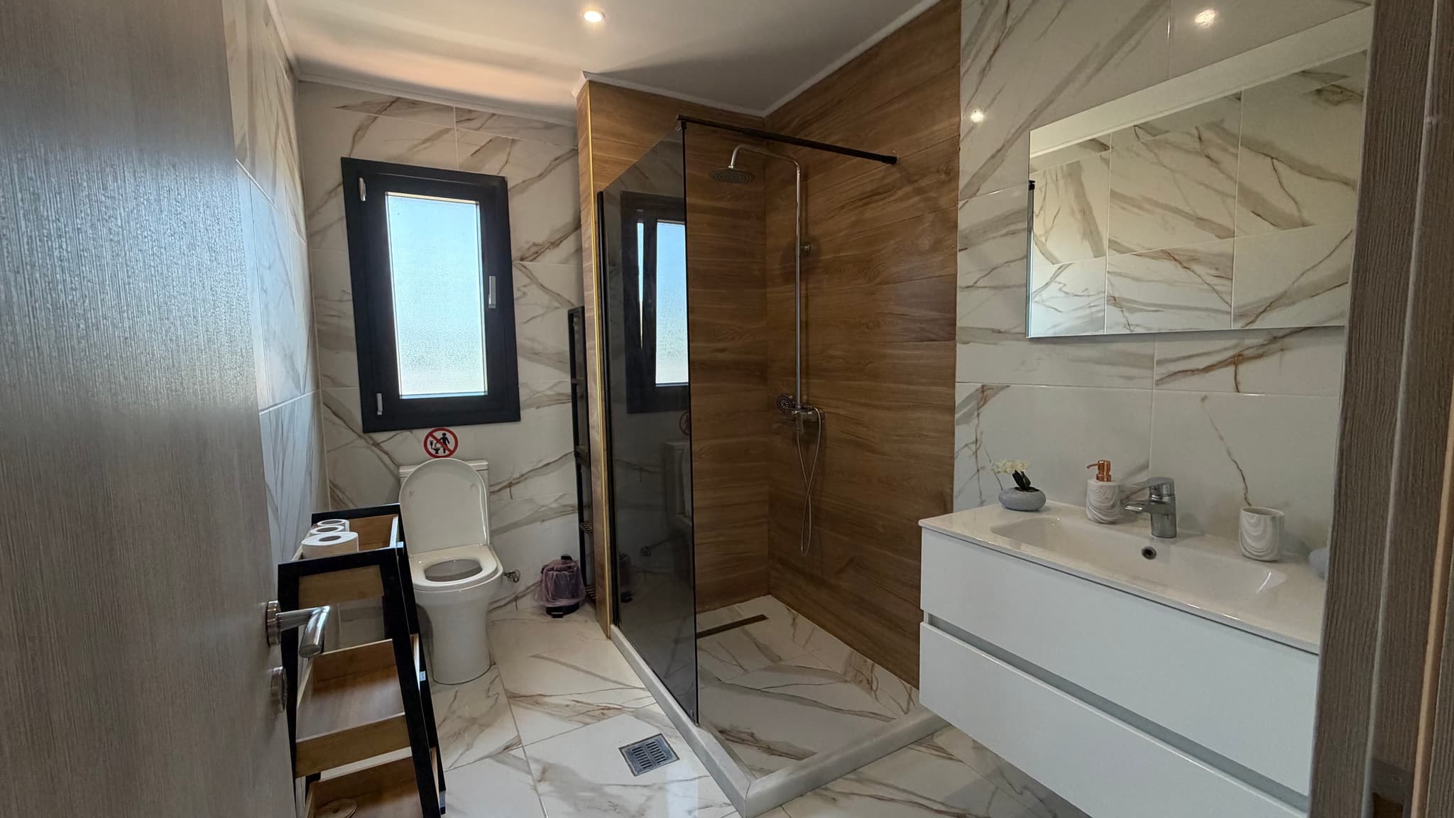 Marble ensuite bathroom with walk-in shower and floating vanity